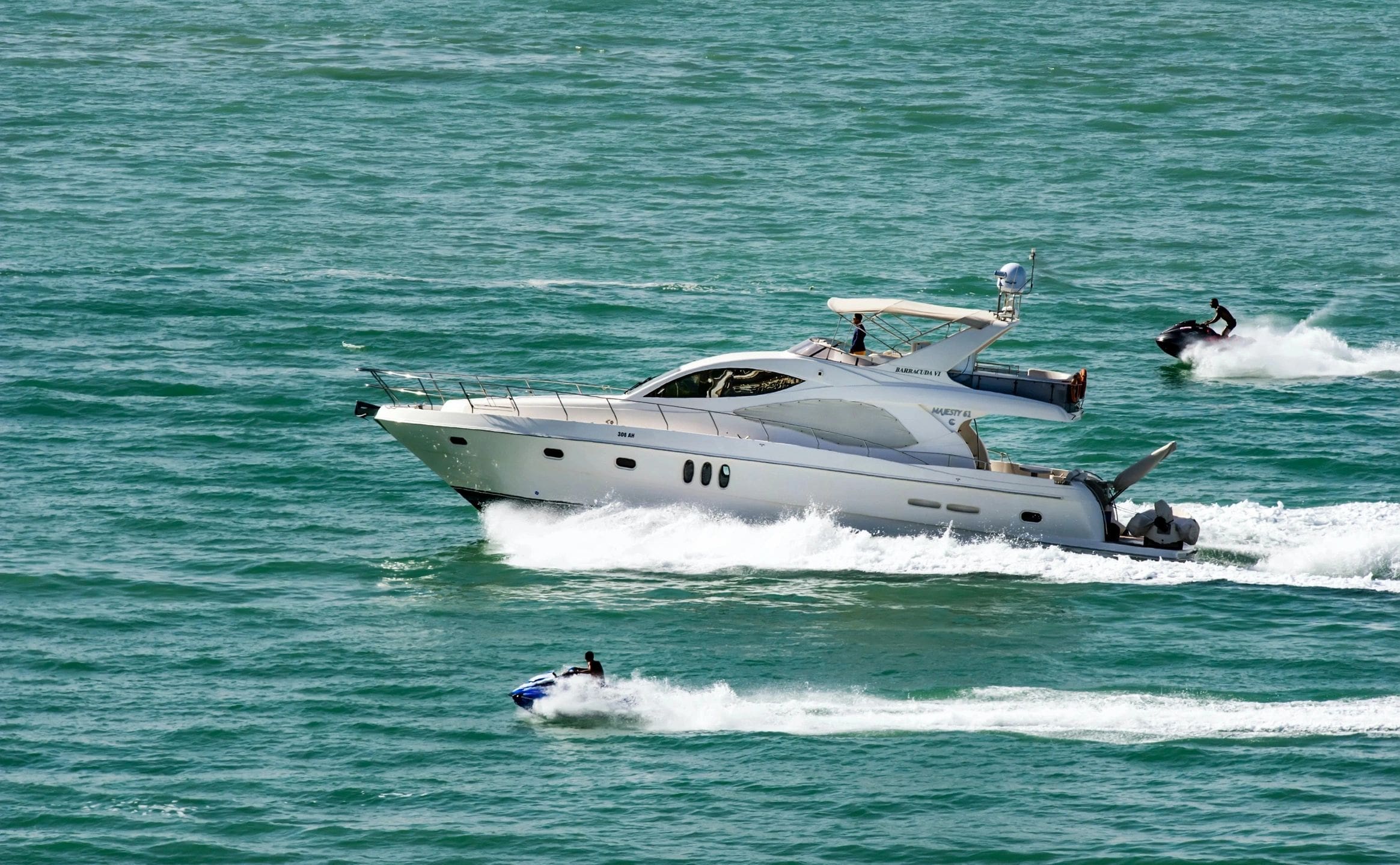 A boat is in the water with two people on it.